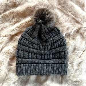Grey beanie with Pom Pom.